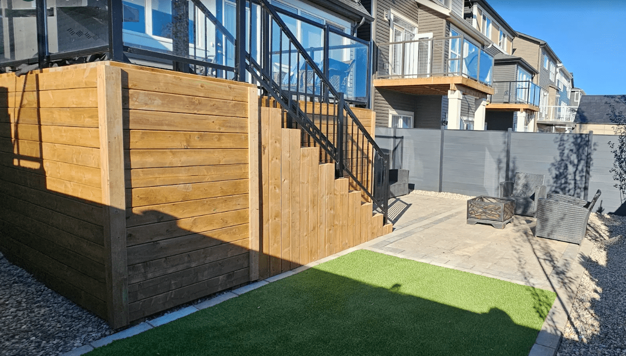 Modern backyard patio with wooden staircase enclosure