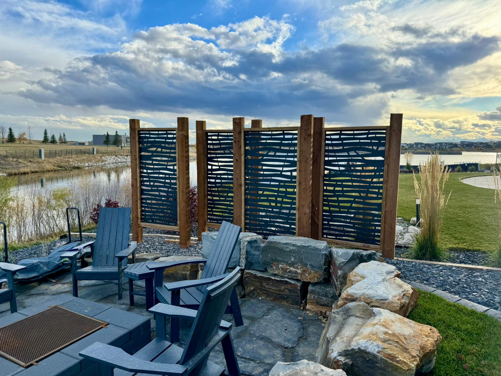 Backyard patio with chairs and decorative privacy screen