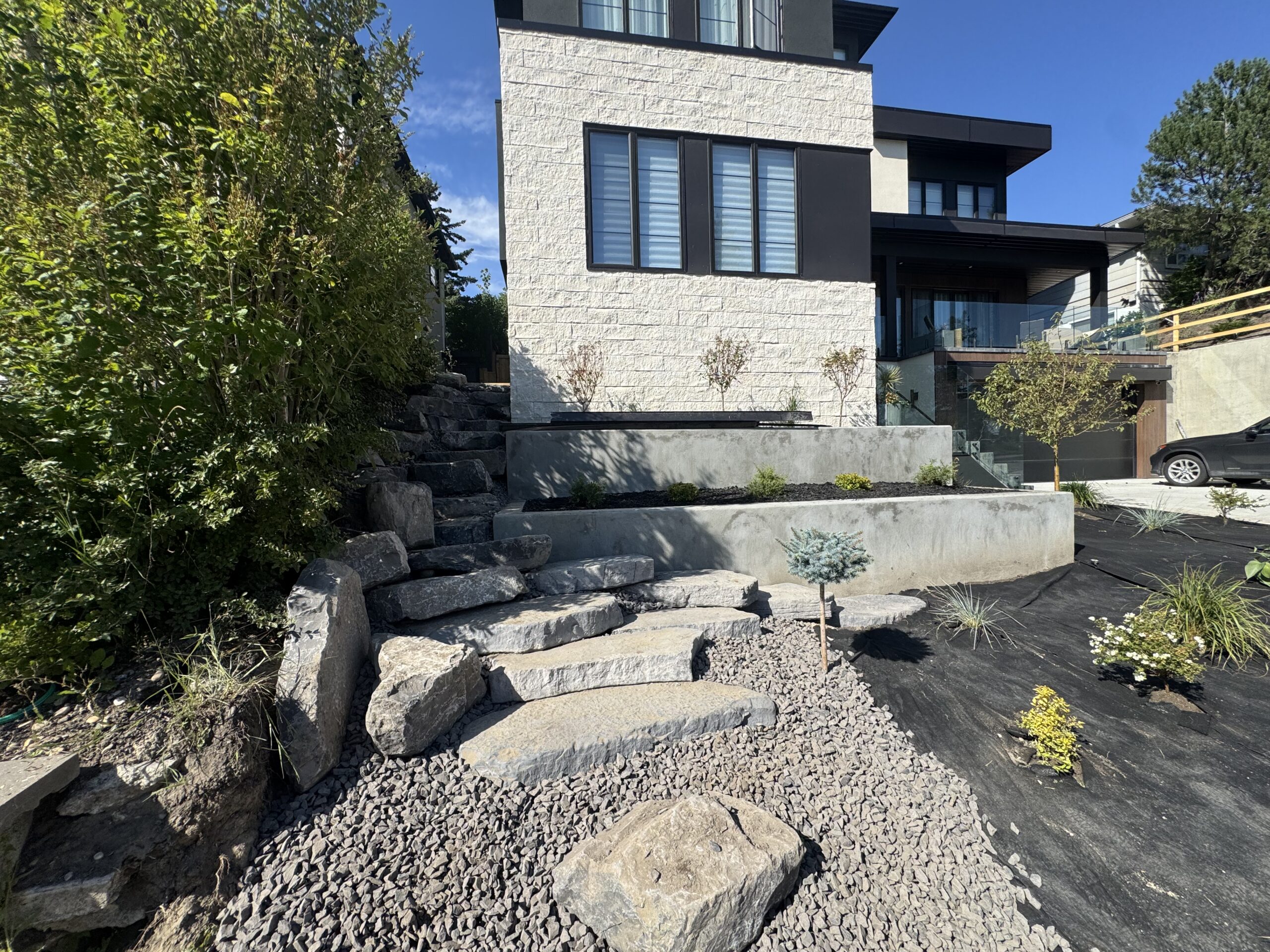 Modern home with stone steps and landscaped yard