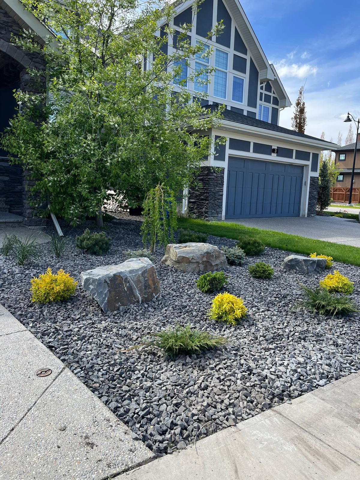 Modern home with landscaped rock garden front yard