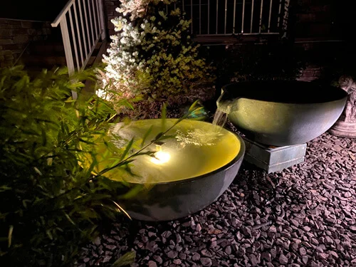 Illuminated garden water bowls at night