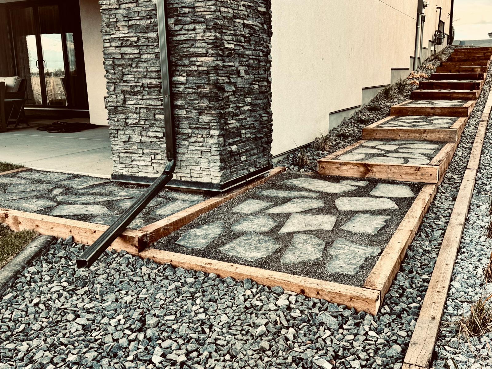 Stone pathway steps beside modern house exterior