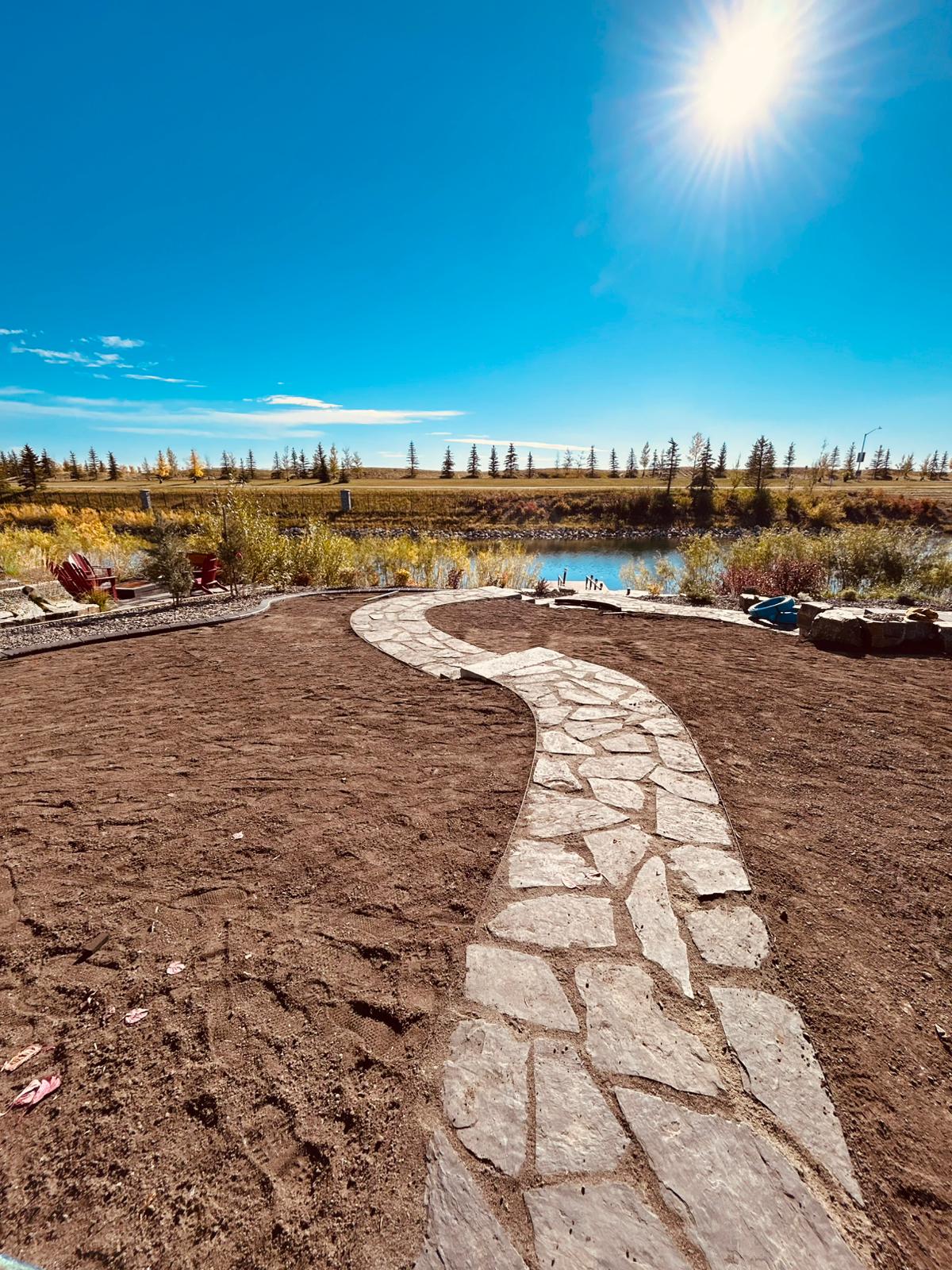 Curved stone pathway leading to riverside backyard