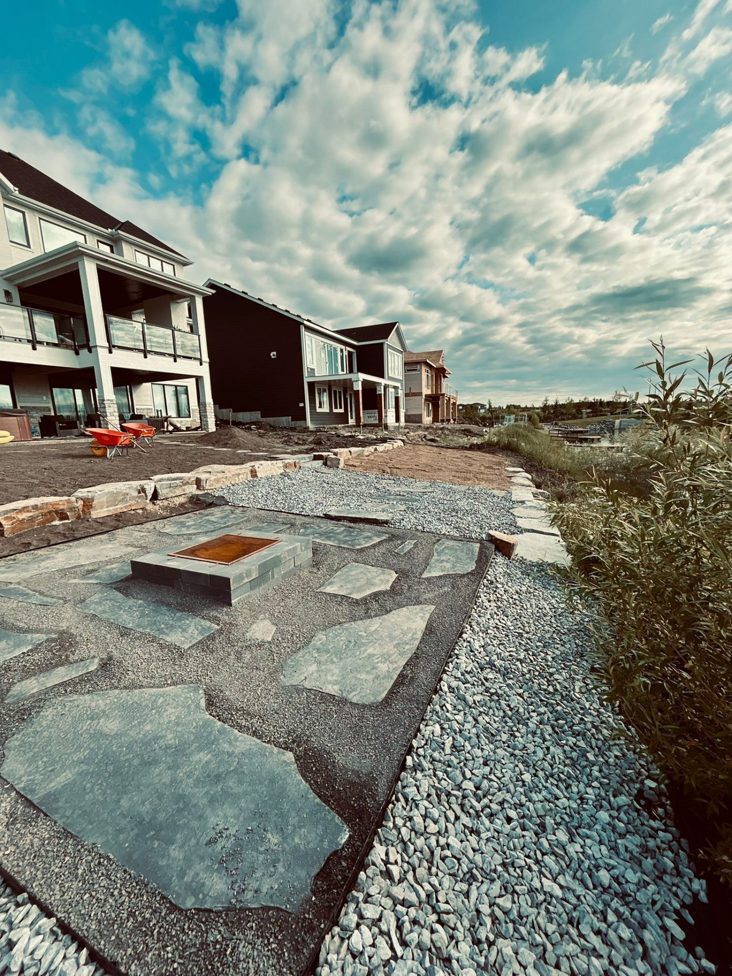 Modern homes with landscaped stone patio and fire pit
