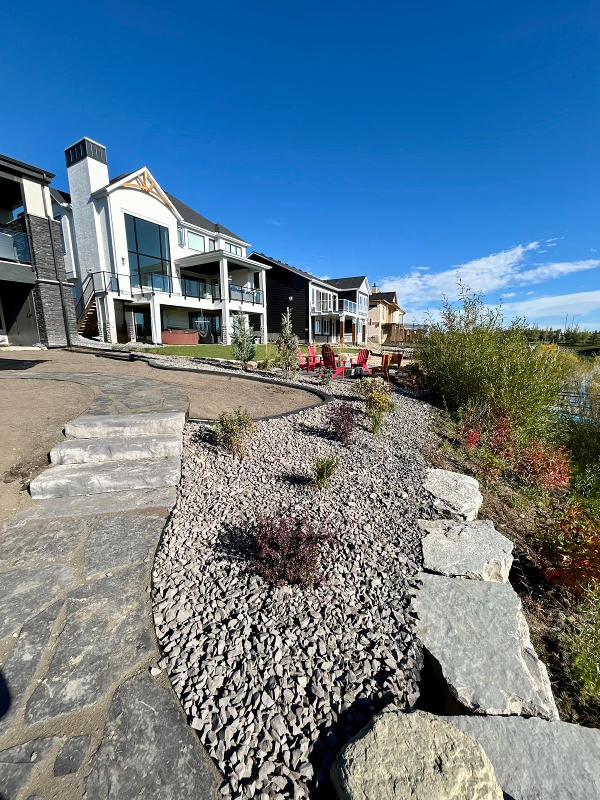 Modern lakeside homes with landscaped backyard and patio