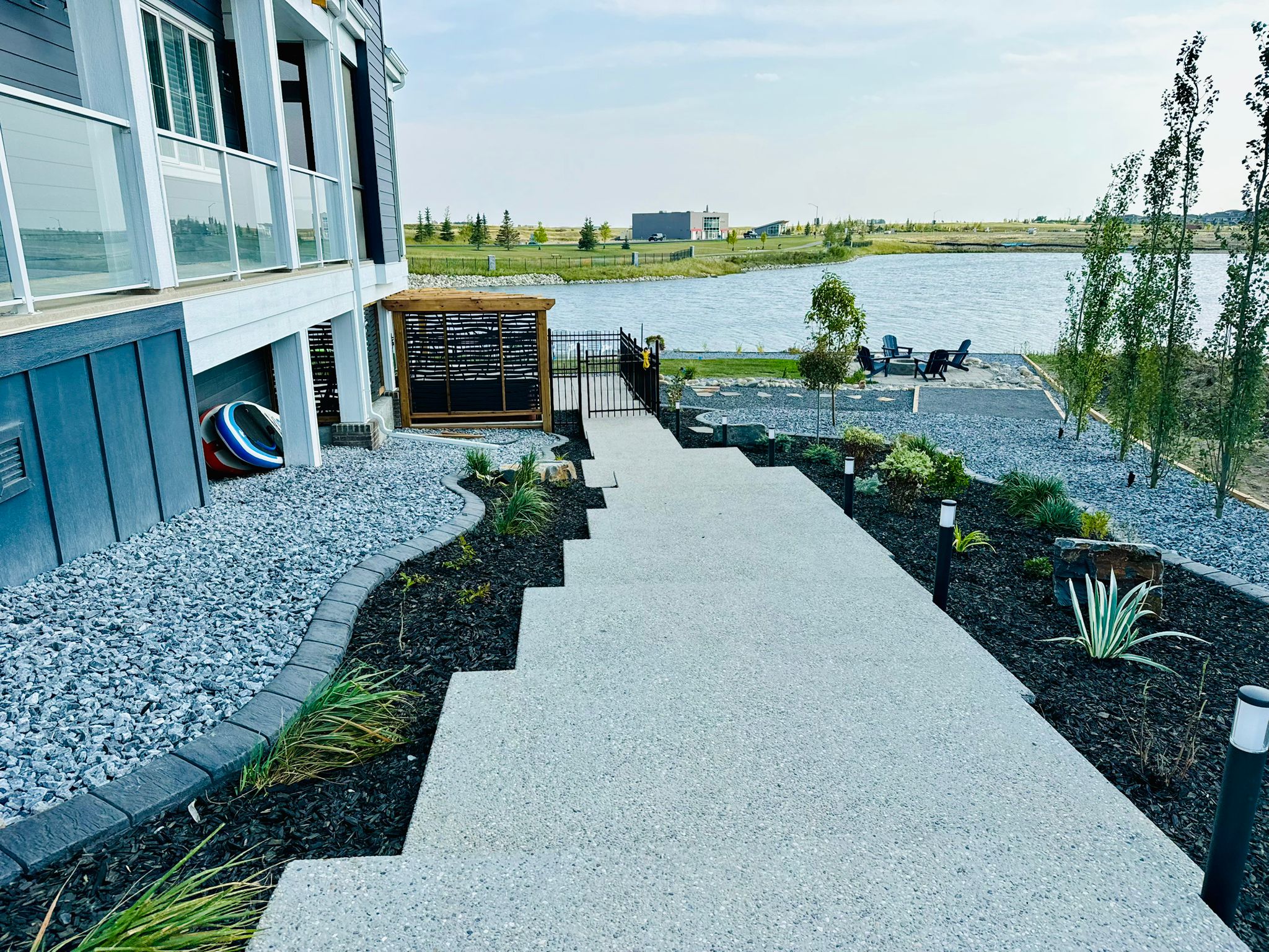 Modern lakeside backyard with patio and seating area