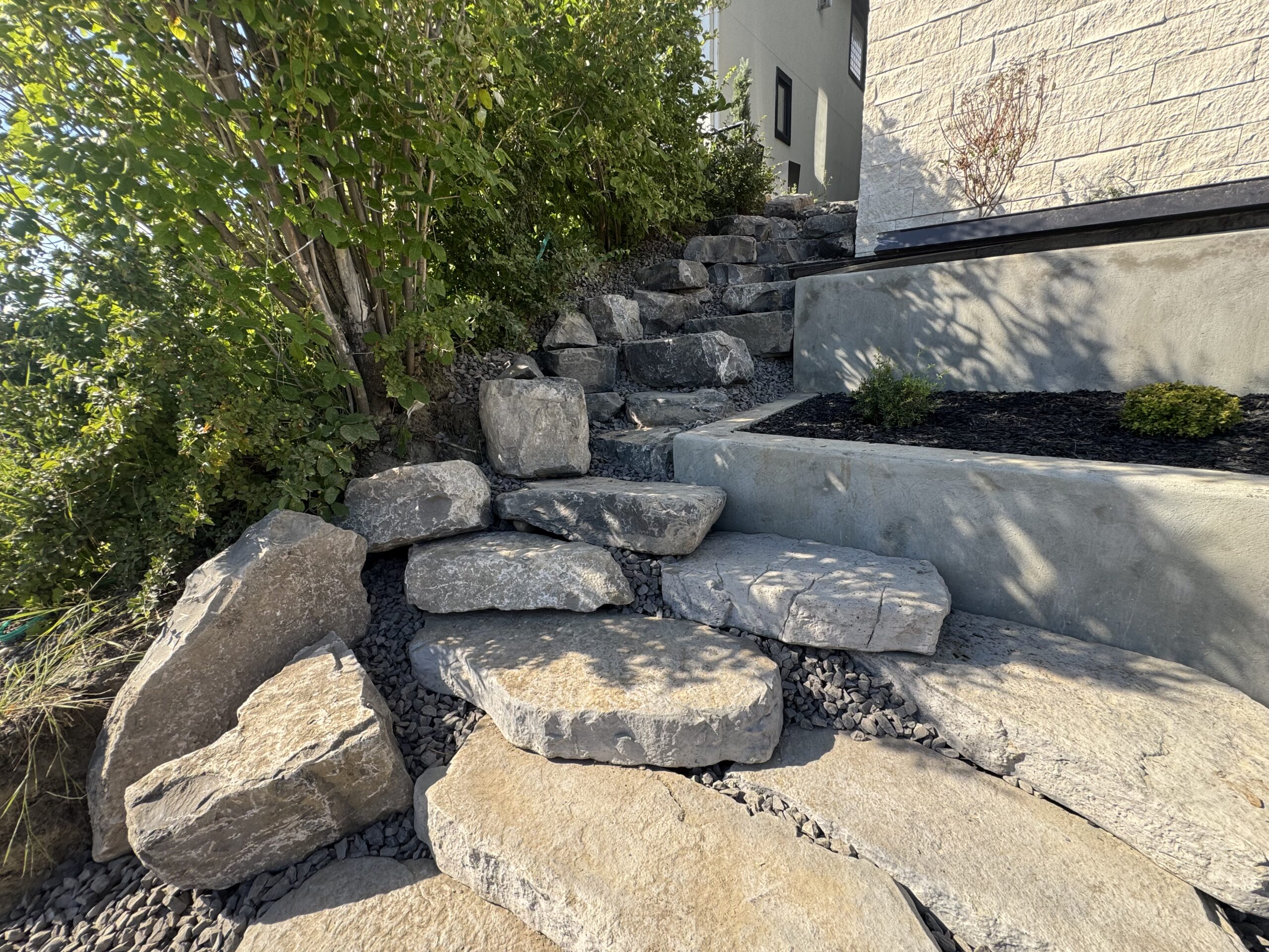 Natural stone steps beside modern home exterior