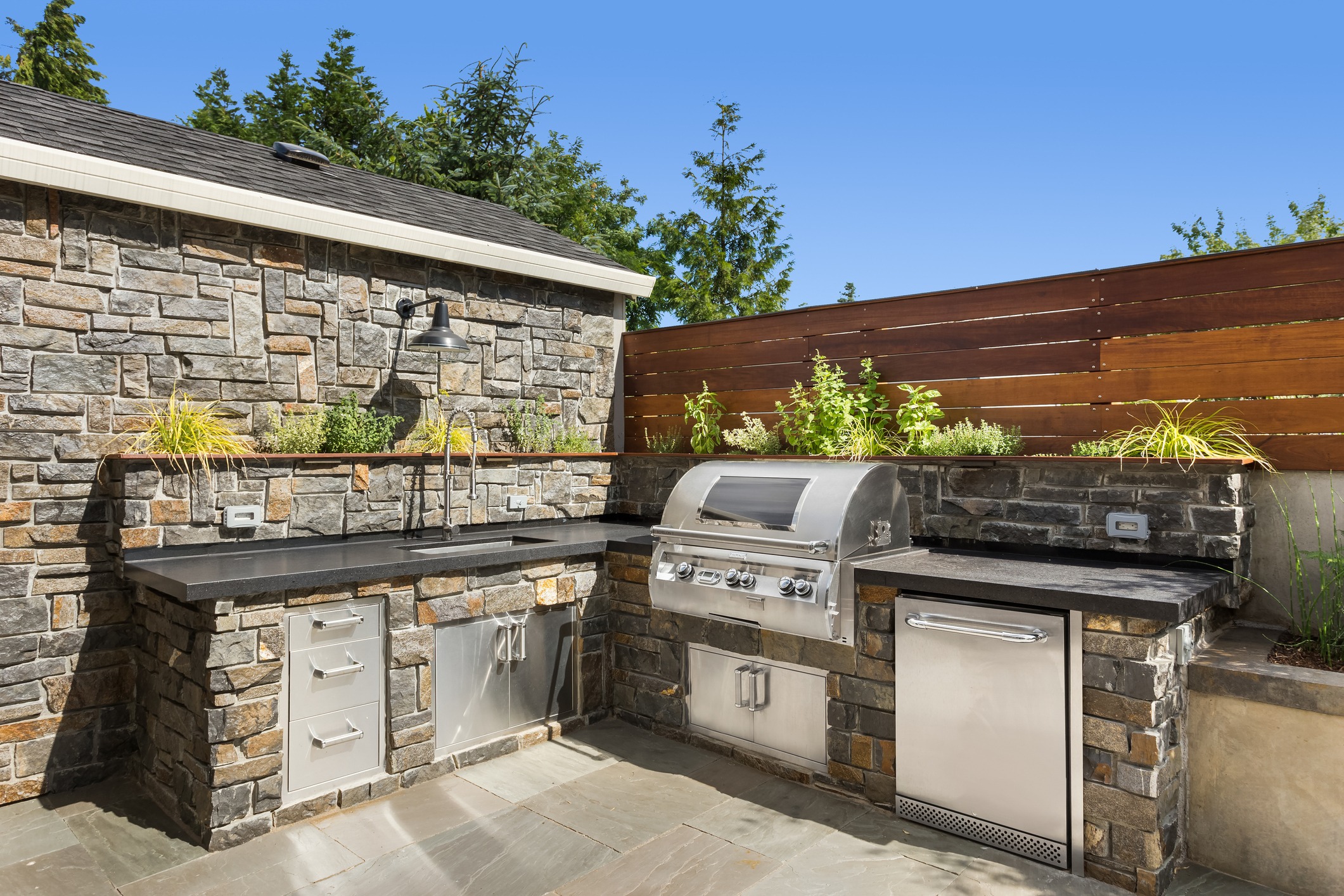 Modern outdoor stone kitchen with stainless grill