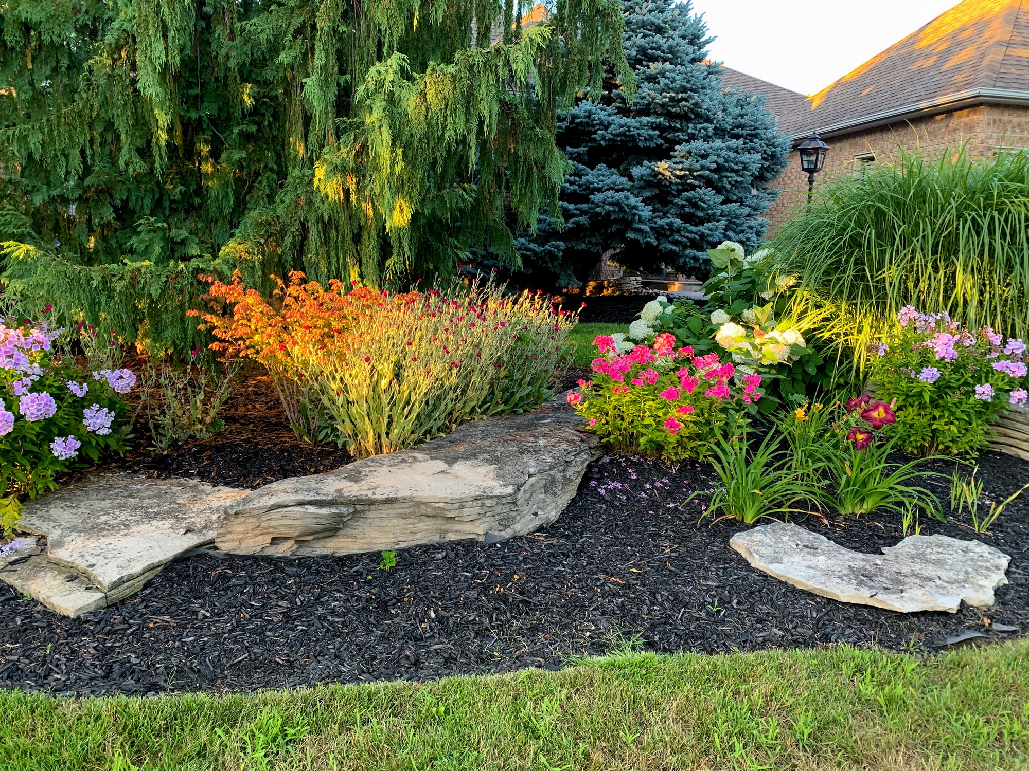 Colorful landscaped garden with flowers and stone border