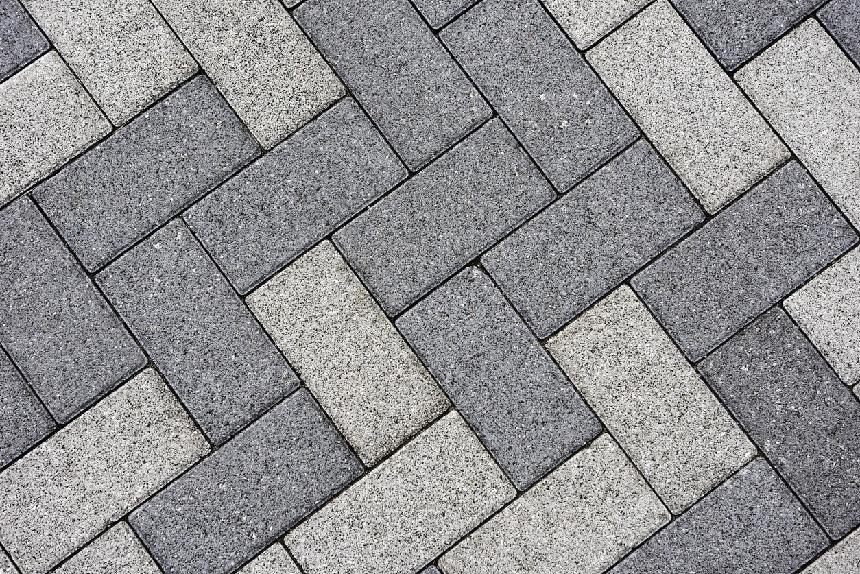 Gray concrete pavers in herringbone pattern
