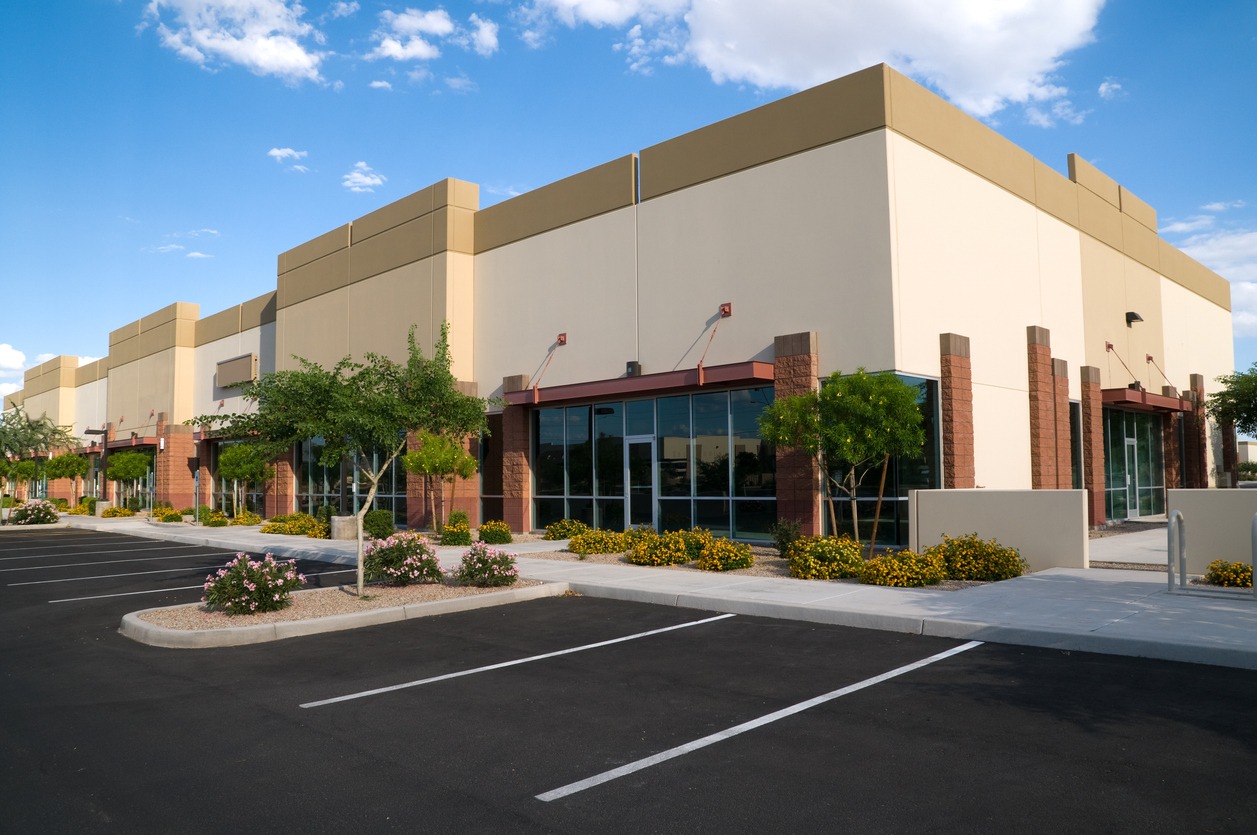 Modern commercial office building with parking lot