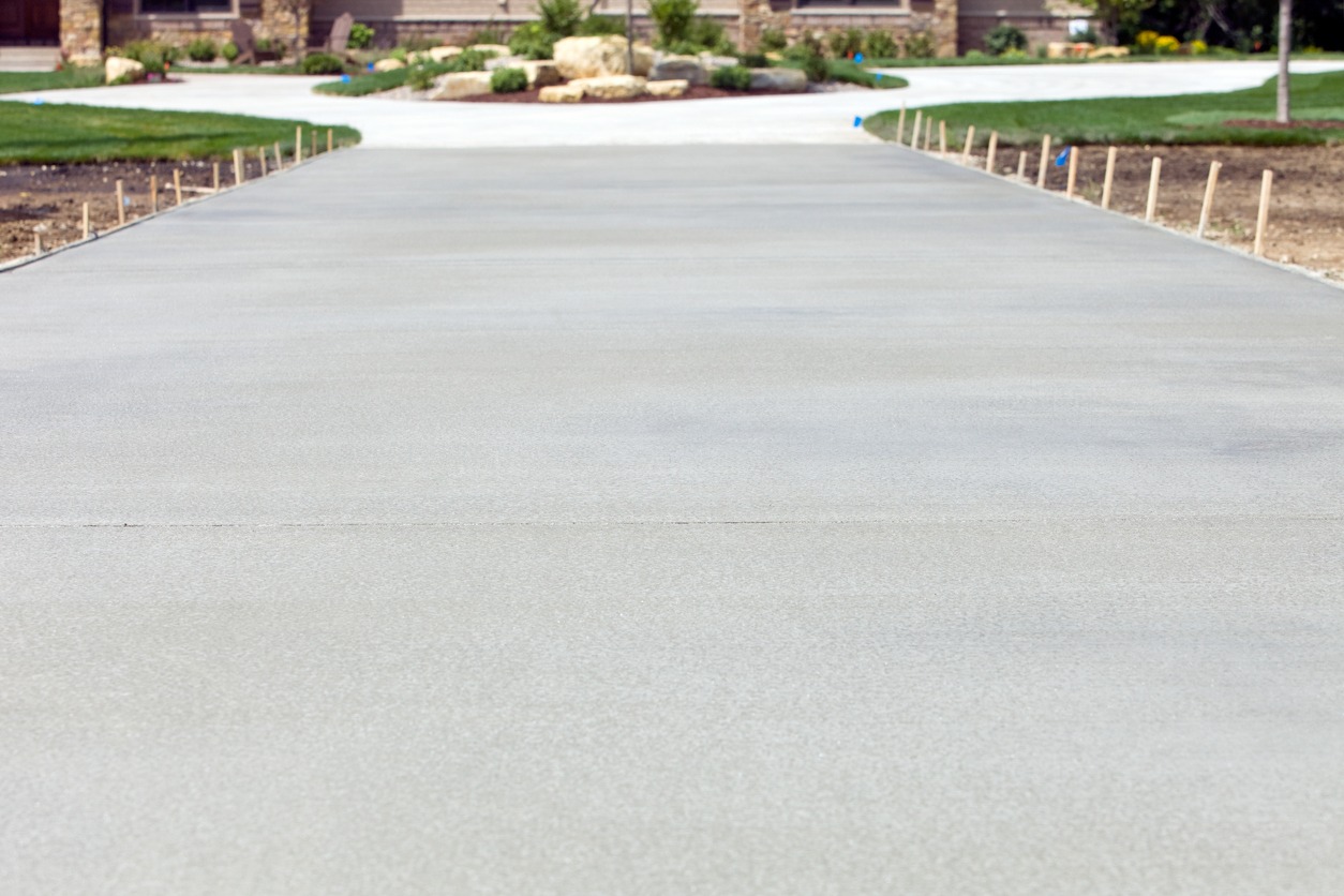 Newly poured concrete driveway in residential neighborhood