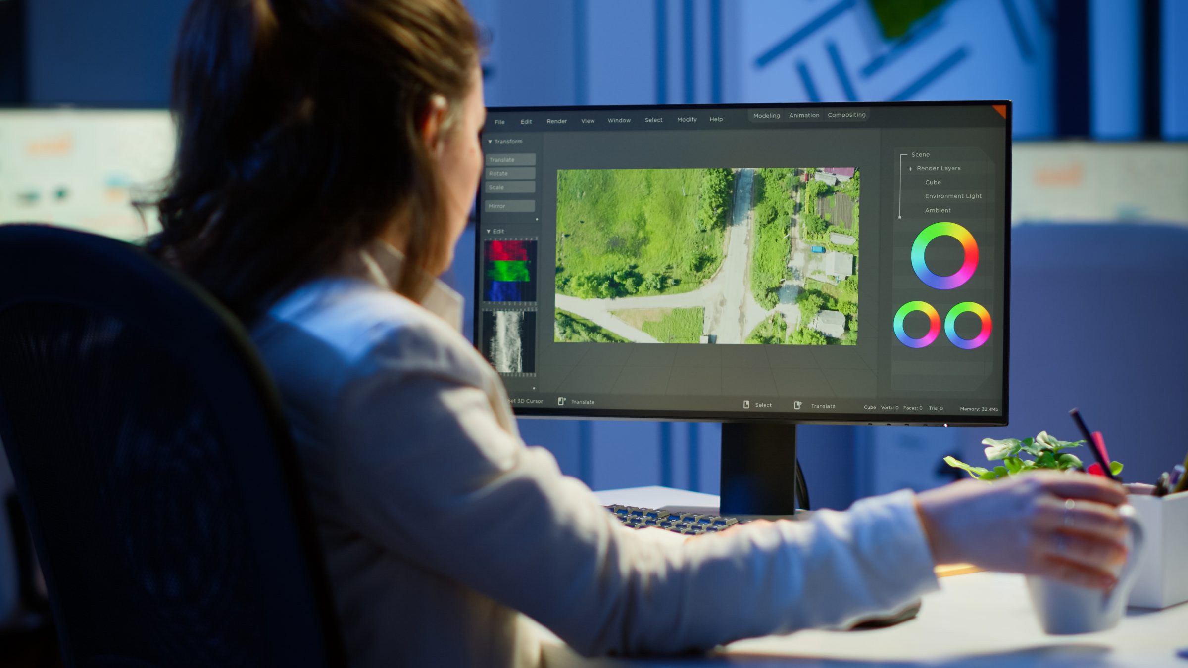 Woman editing aerial video on desktop computer