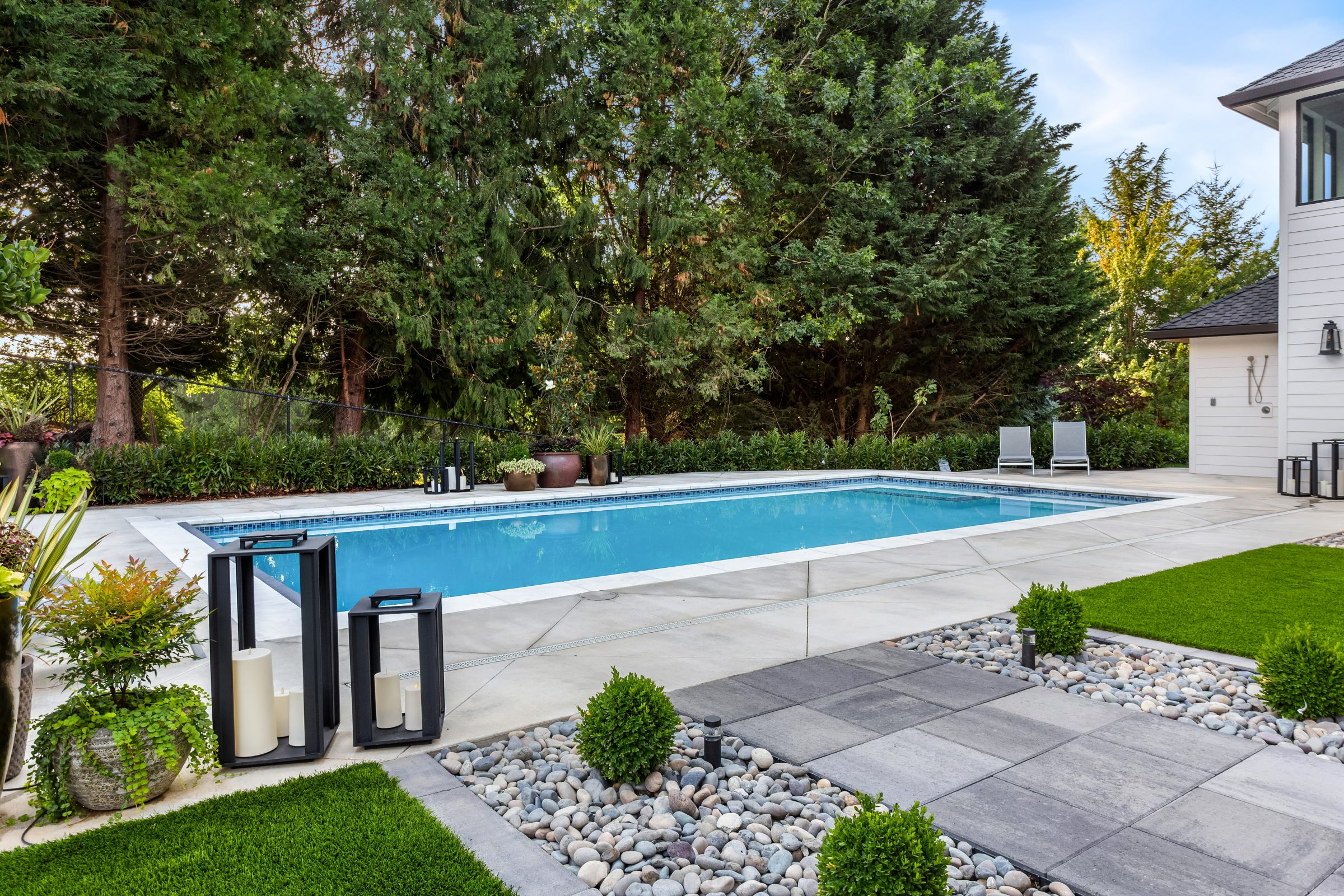 Modern backyard with rectangular pool and landscaped patio