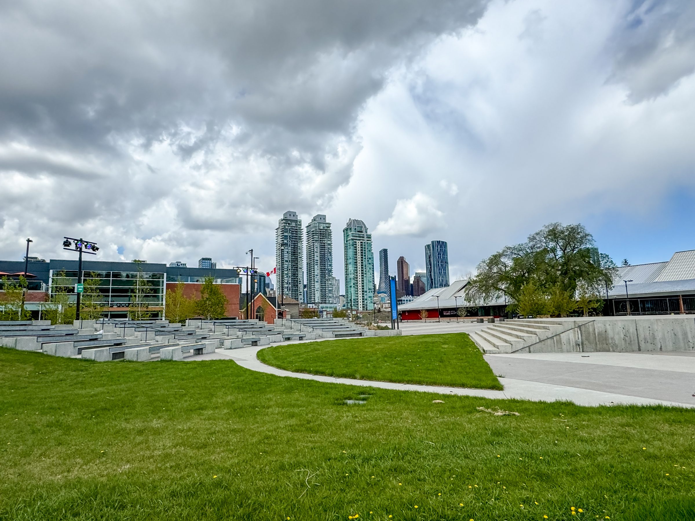 Urban park with skyline under dramatic clouds