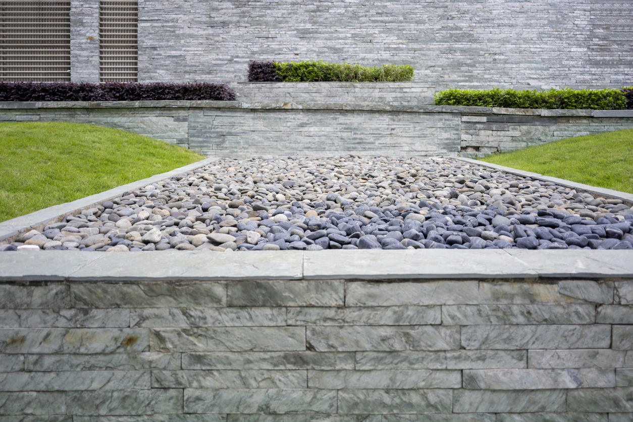Modern stone pebble garden with landscaped lawn